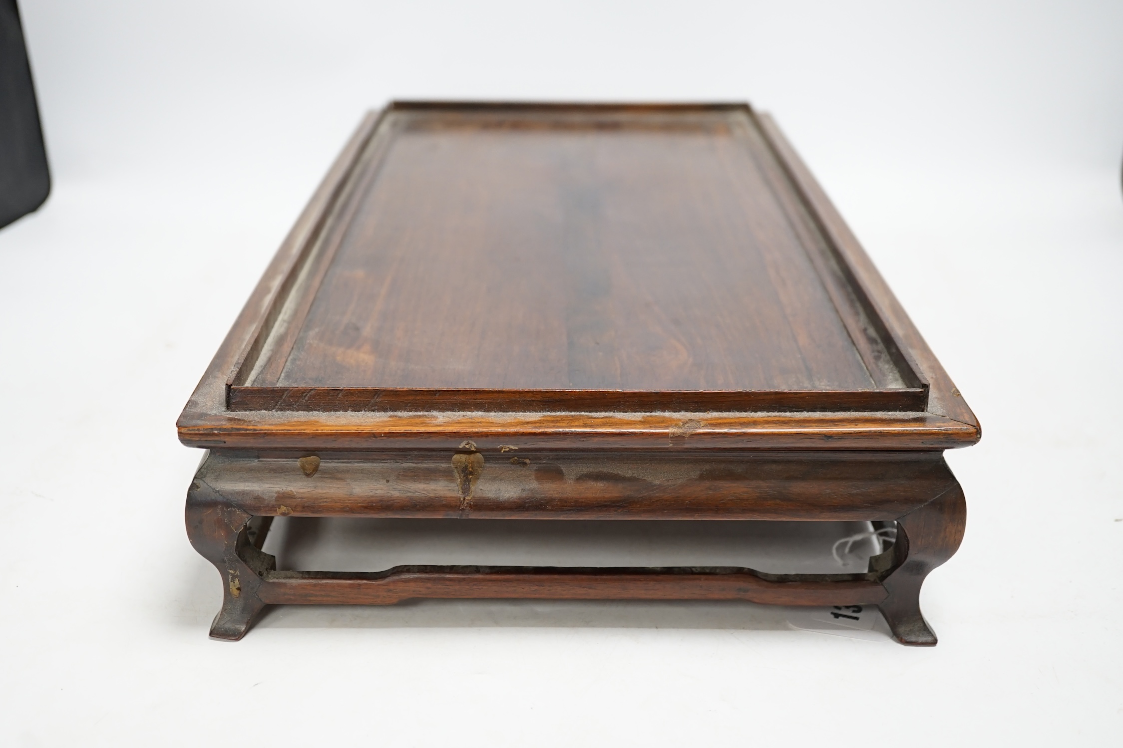 A 19th century Chinese rosewood rectangular stand, 48.5cm wide, 26cm deep, 10cm high. Condition - fair to good